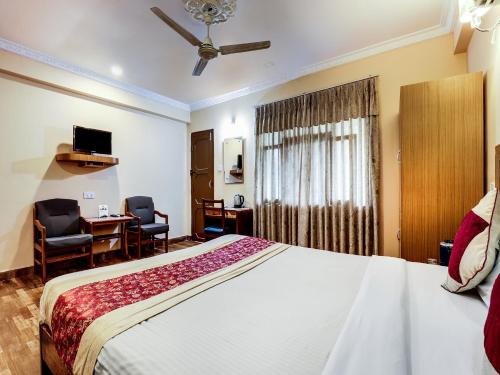 a hotel room with a large bed and a desk at Hotel Wildlife Camp in Sauraha