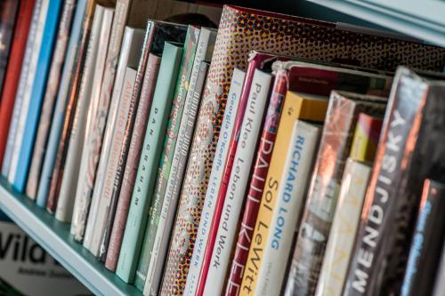 a book shelf filled with lots of books at Le Grand Bellevue in Gstaad