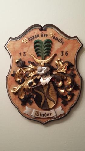a clock on a wall that has ageons at Haus Binder in Ried im Zillertal