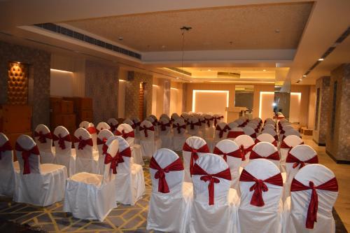 a bunch of chairs with bows on them in a room at Hotel Deep Clarks Inn Lucknow in Lucknow