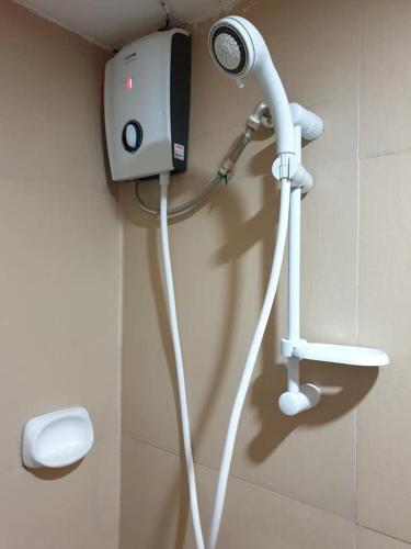 a shower with a blow dryer attached to a wall at La Primera Grande Beach Resort in Roxas