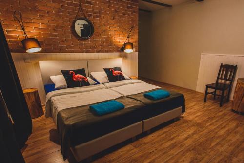 a bedroom with a bed with two birds on it at Leśna Oaza in Borek
