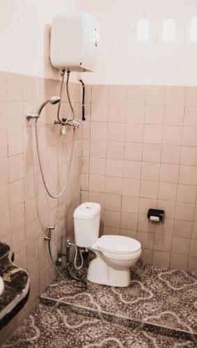 a bathroom with a toilet and a shower at Ayodya Batur Villa in Kintamani