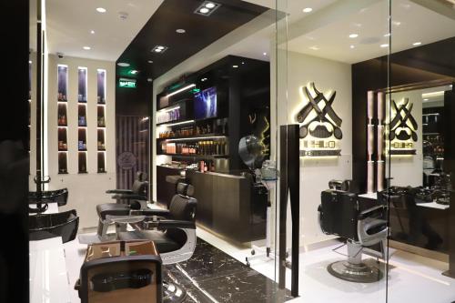 a hair salon with chairs and a barber shop at Golden Tulip Media Hotel in Dubai