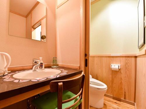 a bathroom with a sink and a toilet at Kirinosato Takahara in Tanabe
