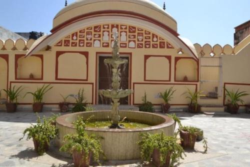 a large building with a fountain in front of a building at Rawla Mrignayani Palace in Jaipur