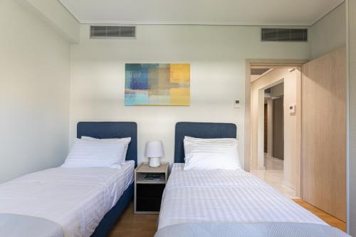 Ένα ή περισσότερα κρεβάτια σε δωμάτιο στο Olygreen Athens Residences