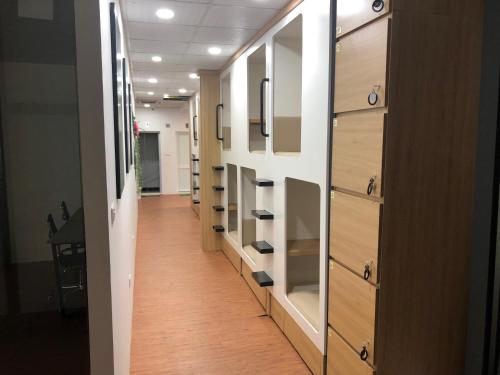 a corridor of an office with wooden drawers at Techgarden Workstay Dorm - Coworking Space in Hanoi