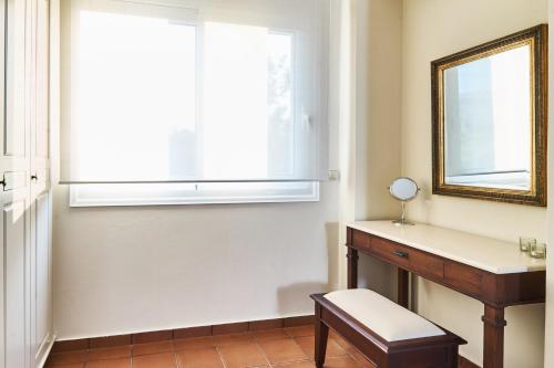 a bathroom with a window and a desk and a mirror at Villa Harma-Exopolis in Georgioupolis