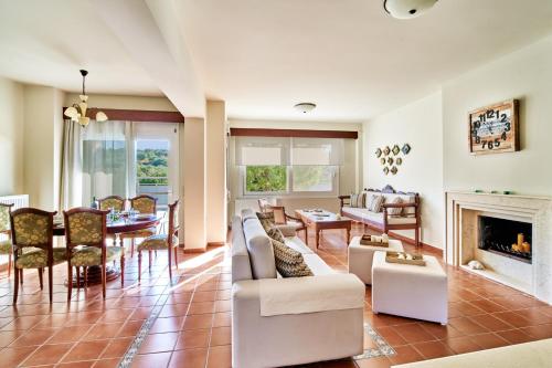 a living room filled with furniture and a fireplace at Villa Harma-Exopolis in Georgioupolis