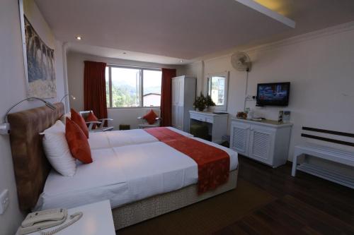 Säng eller sängar i ett rum på Orient Hotel