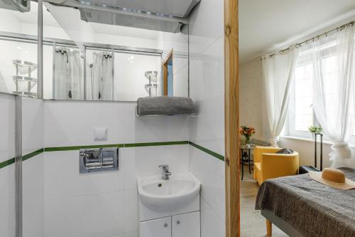 a bathroom with a sink and a mirror at Apartament w centrum Starówki Old Town in Gdańsk