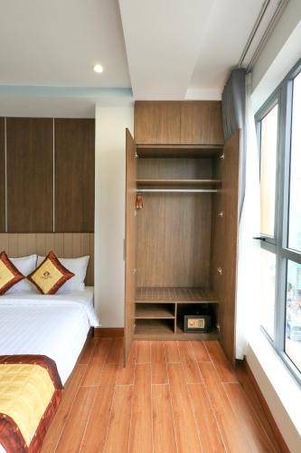 a bedroom with a bed and a large window at Prague Saigon Airport Hotel in Ho Chi Minh City