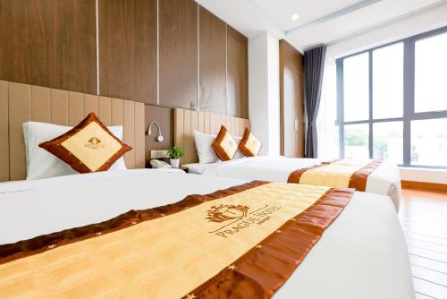 a hotel room with two beds in a room at Prague Saigon Airport Hotel in Ho Chi Minh City