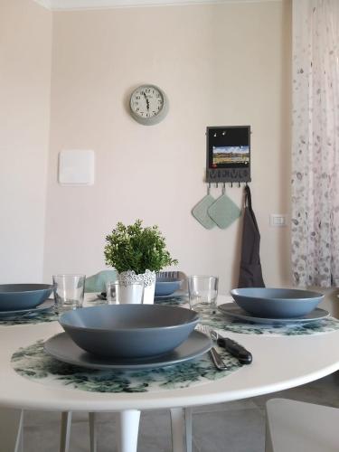 a white table with two bowls on top of it at La magia delle Langhe appartamenti con vista in Novello