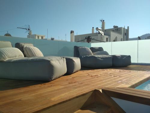 
a living room filled with furniture and a boat at Majestique of Naxos in Naxos Chora
