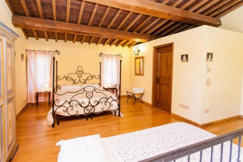 a bedroom with a bed and a wooden floor at Podere Caldaruccio La Pineta in Bosco