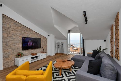 a living room with a couch and a tv at Villa Sukara in Makarska