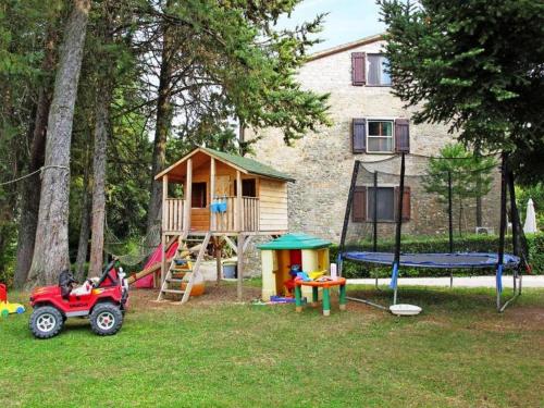 a backyard with a play set and a house at Podere Caldaruccio La Pineta in Bosco