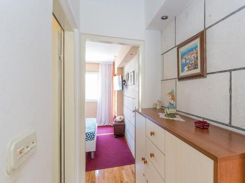 a room with a desk and a room with a bedroom at Romantic apartments Marko for 2 with pool and grill in Zaton
