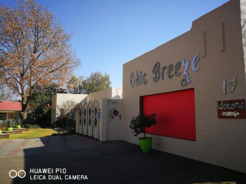 a building with a red garage door on it at Chic Breeze in Bloemfontein