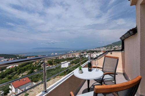 a balcony with a table and chairs and a view at Villa Sukara in Makarska