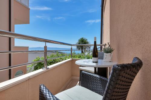 a balcony with a table and chairs and a view at Villa Sukara in Makarska