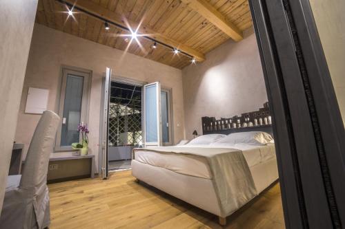 a bedroom with a large bed and a window at Edward Rooms & Wellness B&B in Trani