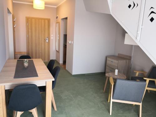 a dining room with a table and chairs and a staircase at HOTEL*** NAT Bukowina Tatrzańska in Bukowina Tatrzańska