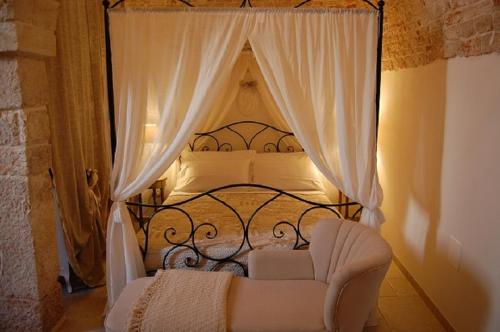 a bedroom with a black and white bed with a chair at La Cantina in Alberobello