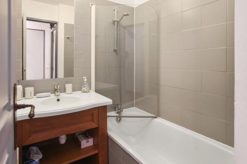 a bathroom with a sink and a shower and a tub at Residence Les Terrasses d'Azur - maeva Home in Isola 2000