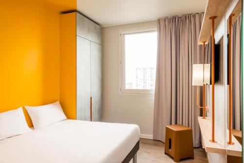 A bed or beds in a room at ibis budget Lyon Est Beynost
