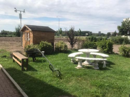 a picnic table and a bench in a yard at i-Motel in Obertshausen