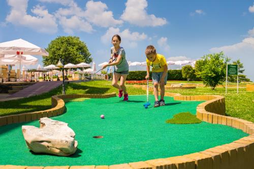 two people playing golf on a miniature golf course at Park & Spa Hotel Markovo in Plovdiv
