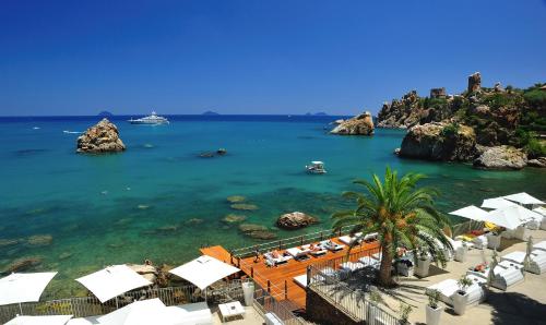 a view of a beach with a resort and the ocean at Le Calette N.5 in Cefalù