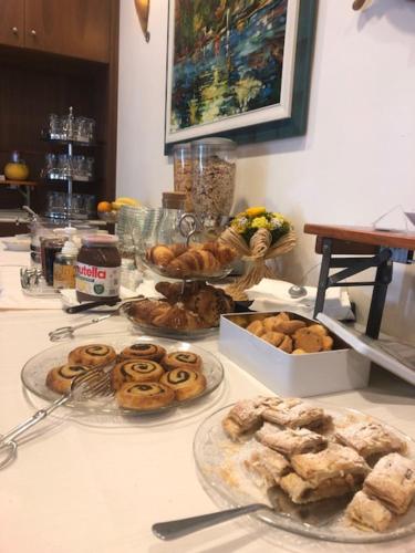 a table with several plates of pastries on it at RTA Doria in Garda
