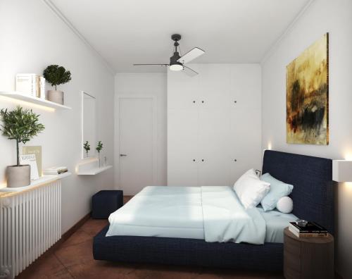 a bedroom with a bed with a blue headboard at P & G Apartment in Pámfylla