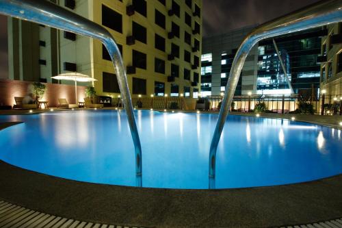 a large swimming pool in the middle of a building at Sterlings Mac Hotel in Bangalore