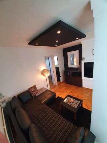 a living room with a couch and a tv at Apartment New Belgrade Home in Belgrade