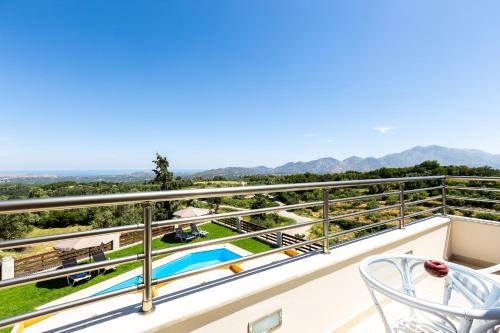 a view from the balcony of a house with a swimming pool at Anatoli Villa, Tranquil Retreat, By ThinkVilla in Orthés