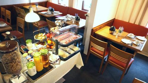 a table with food on it in a restaurant at Hotel Kieler Hof in Hamburg