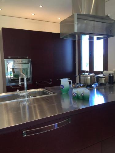 a kitchen counter with a sink and a stove at CASA DI MADI in Chalkida