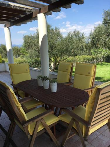 a wooden table and chairs on a patio at CASA DI MADI in Chalkida