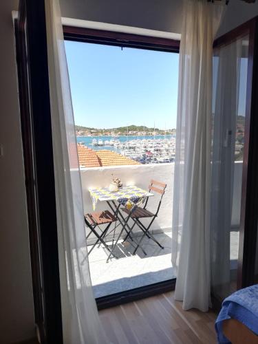 a view of a balcony with a table and chairs at Apartman Dino in Murter