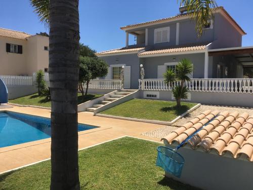 阿爾布費拉的住宿－Villa Vale Carro，一座带游泳池和棕榈树的房子