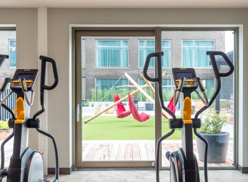 a group of treadmills in a gym with a playground at Olympic Hotel in Amsterdam