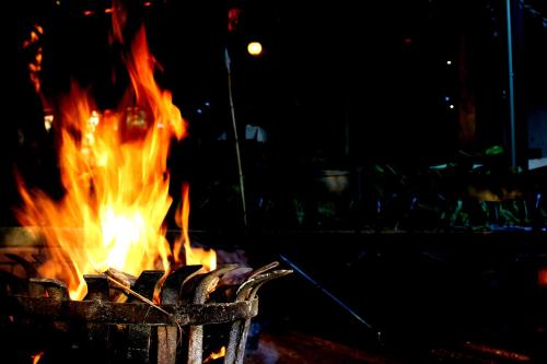 a fire in a trash can at night at Tuskers Bush Lodge B&B in Hartbeespoort