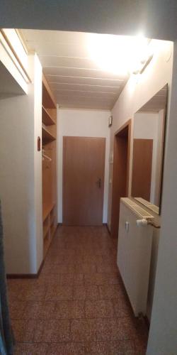 an empty room with a hallway with a closet at Apartmán u potoka in Sadov