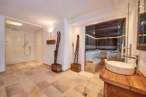 a bathroom with a shower and a sink and a tub at Gut Vögeihof in Forstau