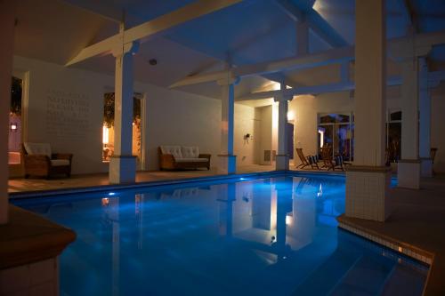 a swimming pool in a hotel at night at Villa Howden in Margate